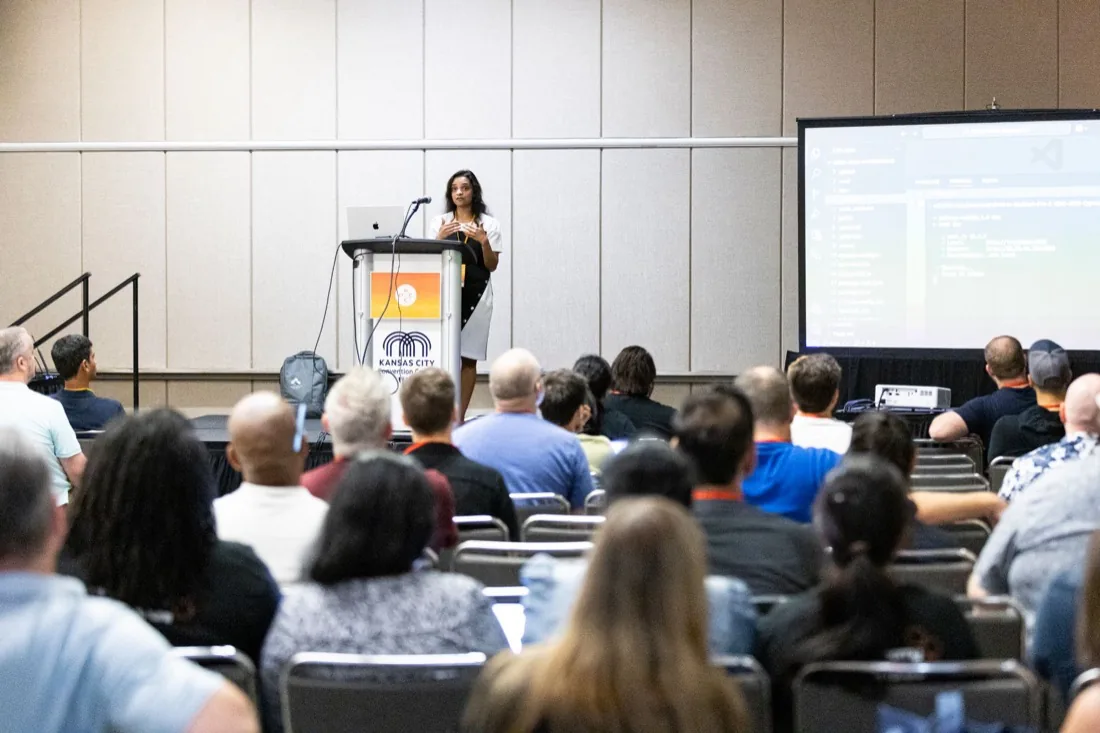 Adhithi Ravichandran presenting on stage at Kansas City Developer Conference
