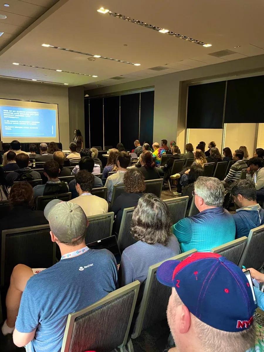 Adhithi Ravichandran presenting to a packed room on team alignment